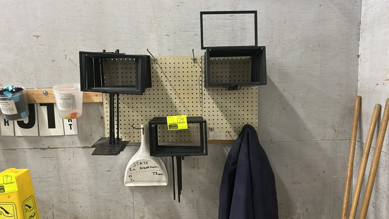 Poly sign frames and stands. Features black plastic construction. Includes various styles with flat base mounts, stems, and frame holders. Pegboard, h