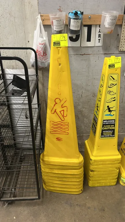 Continental wet floor caution cones. Features yellow polyethylene construction with red caution slip-and-fall graphics. 3-sided stackable design.
