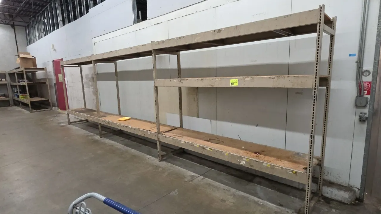 8'L sections of metal warehouse racking. Features 5" crossbars, compressed wood decking, and 2' x 7' uprights. Contents not included.