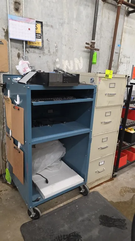 Portable metal workstation and Hon 4-drawer vertical file cabinet. Workstation features a slide-out keyboard tray, storage shelving, and mobile caster
