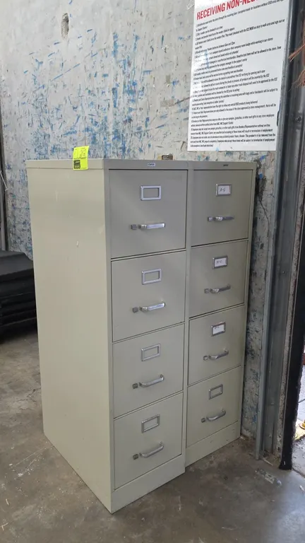 Staples 4-drawer vertical file cabinets. Features metal construction with putty finish, integrated label holders, silver-tone drawer pulls, and intern