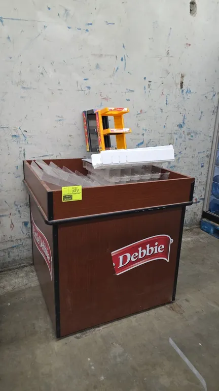 Laminate wood merchandiser display bin. Features a woodgrain laminate finish with Little Debbie graphics and black protective edge trim. Dimensions: 3