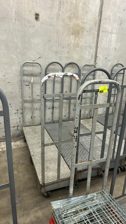 Metal diamond-plate U-boat platform stocking carts. Features dual tall tubular steel end handles and diamond-plate steel deck. 5'L. Mounted on casters