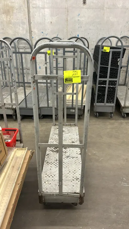 Metal diamond-plate U-boat stock cart. Features dual tall tubular end handles and a diamond-plate platform deck. 4'L. Mounted on casters.