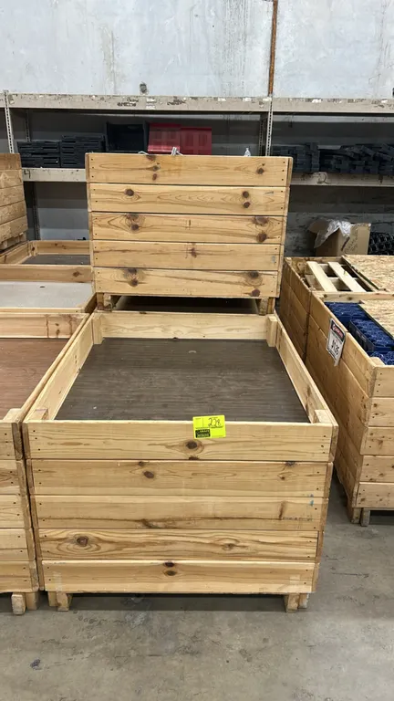 Wooden dump display bins. Features wood slat construction, recessed interior display decks, and integrated riser base for forklift or pallet jack acce