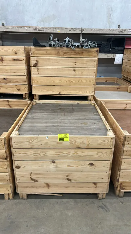 Wooden display dump bins. Features horizontal wood slat construction, faux wood-grain display deck, and integrated pallet-style base for transport. Di