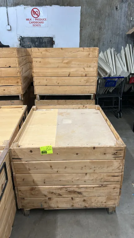 Wooden dump display tables. Features wood plank construction with shallow top display decks and integrated pallet-style bases. Dimensions: 48" x 40".