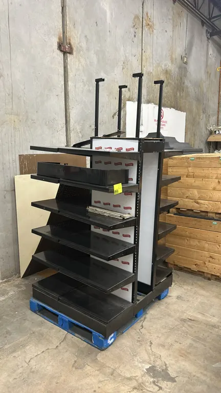 Metal 3-sided multi-tier display merchandiser. Features adjustable black metal shelving, Little Debbie branded back panels, slotted uprights, and over