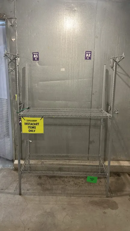 2-tier metal wire shelving rack. Features slotted upright posts and 2 wire shelves. Dimensions: 4'L x 2'W.