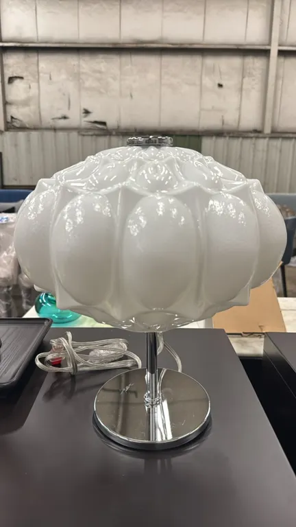 MM Lampadari Arabesque 16985L111 table lamp. Features a molded white glass shade, polished chrome stem, and circular chrome base. Accommodates 1x max