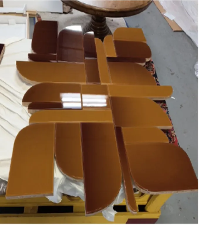 Holly Hunt Elements No. 143 Eclipse Collection wall sculpture. Features a geometric segmented design with high-gloss amber and brown glazed panels on