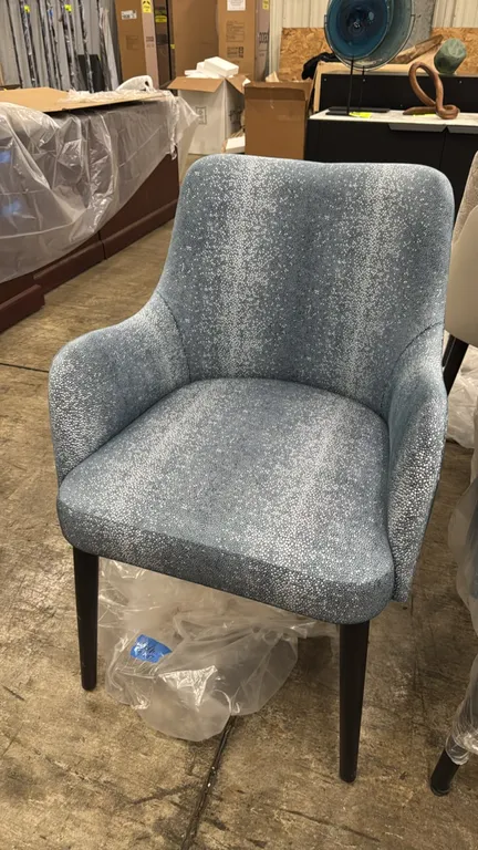Adriana Hoyos Galapagos 100 armchairs. Features blue and silver-tone patterned fabric upholstery with solid slate blue exterior back and tapered dark