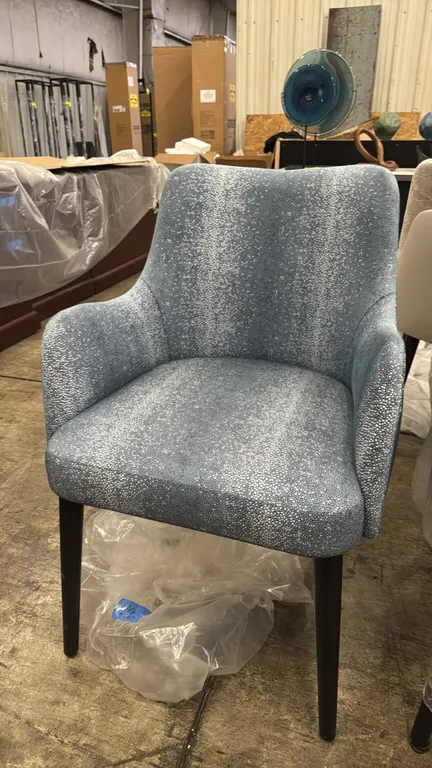 Adriana Hoyos armchairs. Features blue and silver-tone patterned upholstery on the seat and inner back, solid blue upholstered outer back, integrated