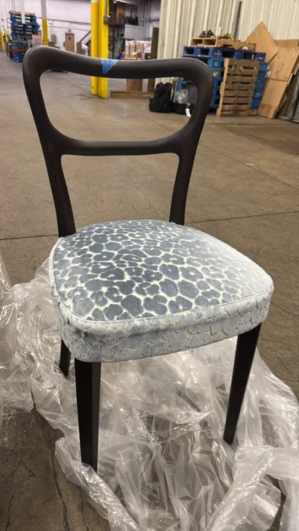 Porada Noemi dining side chairs. Features dark wood frame with curved open backrest, cushioned seat upholstered in a blue and cream patterned velvet-s