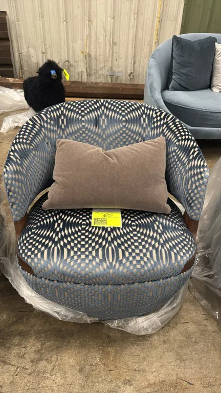 Potocco Velis armchair. Features blue mosaic patterned fabric upholstery, curved barrel back with wood trim accent, and includes accent pillow.