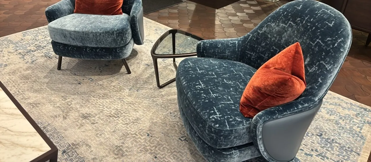 Decorative area rug. Features a blue and ivory geometric fret pattern. 11'L.