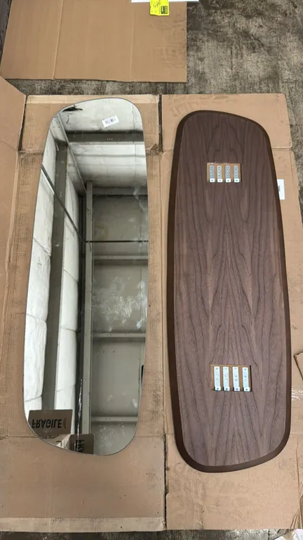 Custom shape wall mirror with wood back. Features an asymmetrical curved design, walnut-finish back panel, and integrated rear mounting brackets. Dime