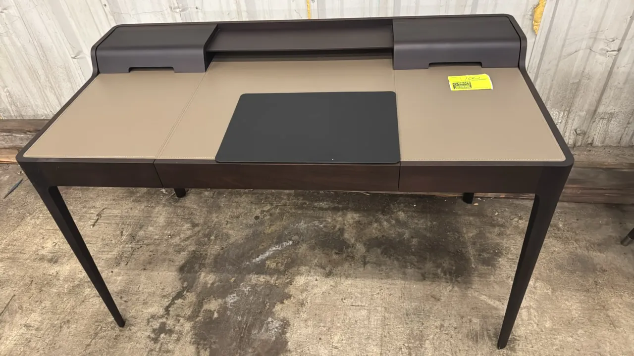 Porada Saffo desk. Features dark wood finish, stitched leather-inlaid writing surface, single center storage drawer, rear raised shelf with hinged cab