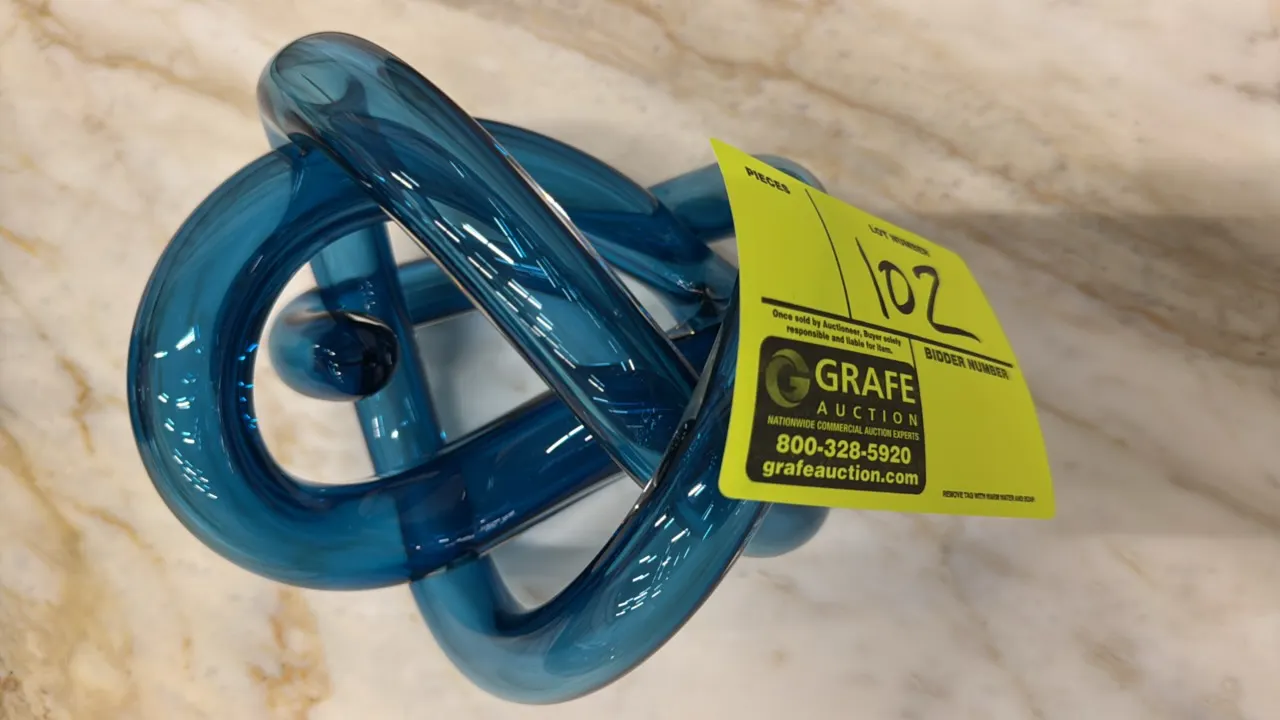 SkLO FL114SBL Wrap Object glass sculpture. Features hand-blown steel blue glass in a continuous looped knot design. Made in Czech Republic. 7". Includ
