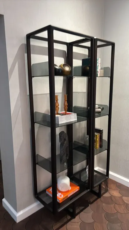 Porada Myria 2-piece bookcase. Features dark wood frame construction and smoked glass shelves with integrated bookends. Dimensions: 39" x 16" x 80". F