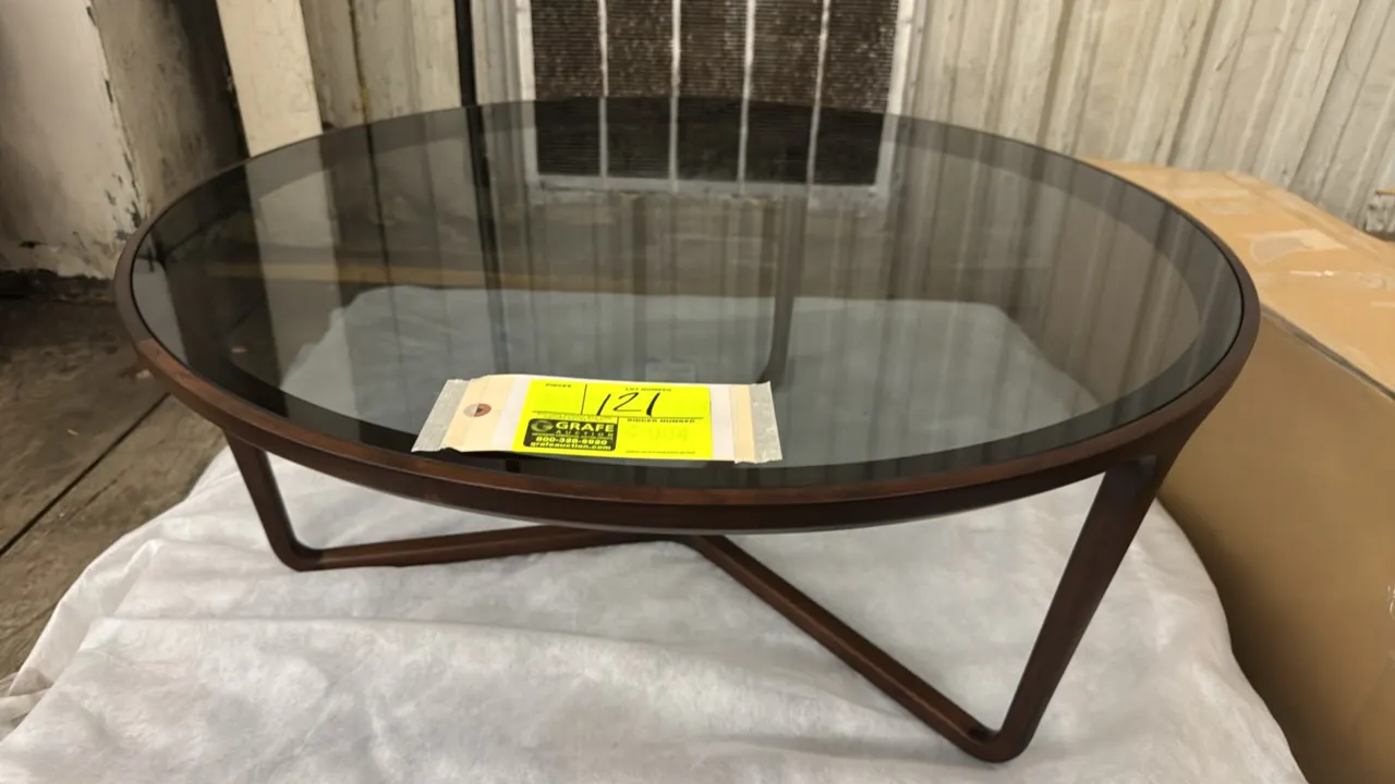 Ceccotti Collezioni round coffee table. Features a sculpted solid wood frame, tri-leg base design, and inset tinted glass top. 35"Dia. x 14"H.