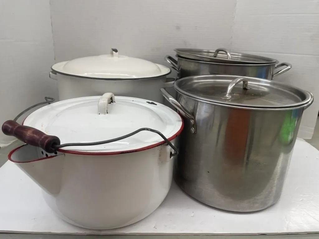 Enamelled and stainless steel pots with lids. One