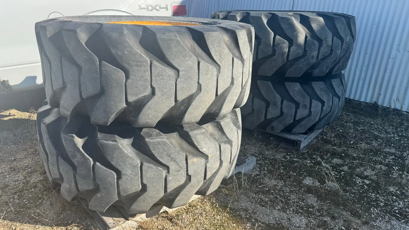 4) Tires on wheels removed from JD wheel loader