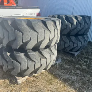 4) Tires on wheels removed from JD wheel loader