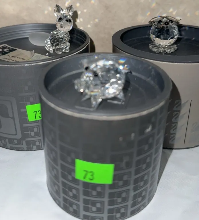 3 Crystal Animal Figurines with Black Accents on Cylindrical Boxes