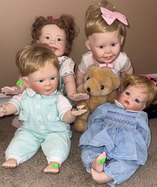 Four Ashton Drake Porcelain Baby Dolls with Assorted Outfits and Teddy Bear