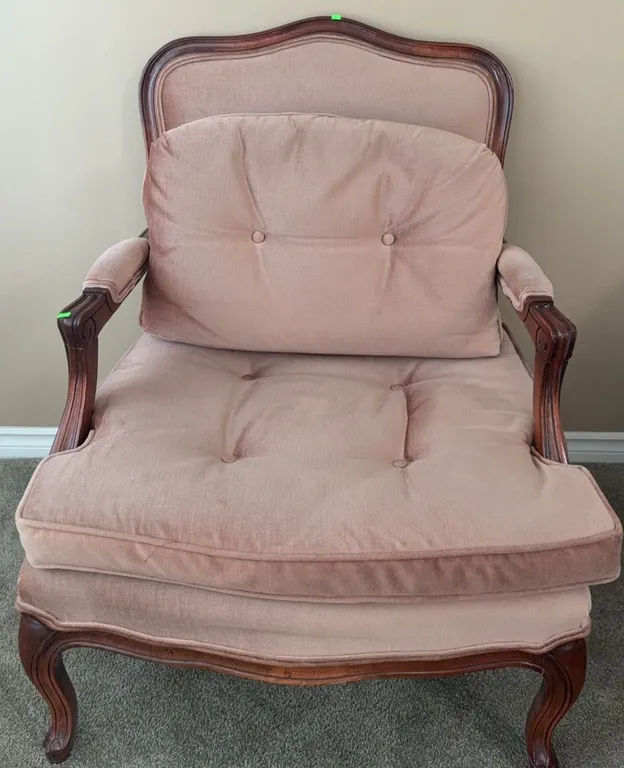 Upholstered Wood Armchair with Carved Details and Pink Cushions