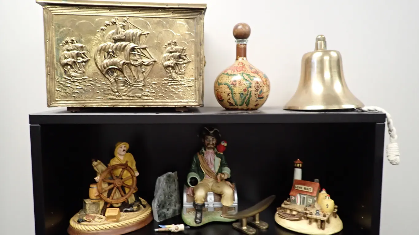 Lot of (3) Ceramic Nautical Figurines, Brass Bell, Pirates Booty Chest and Rum Bottle.