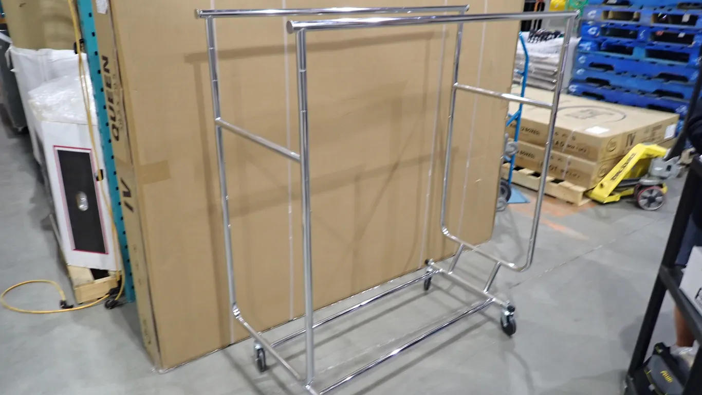Lot of (7) Mobile Double Bar Retail Clothing Racks and (2) Mobile Single Bar Retail Clothing Racks.