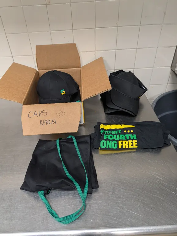 Assorted Caps, Aprons, and Shirts