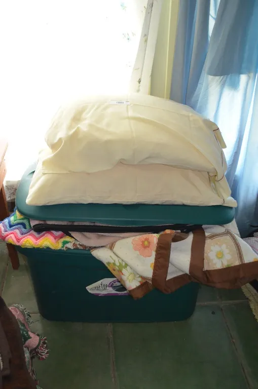 Plastic Tote w/ Bedding and afghans