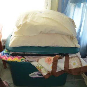 Plastic Tote w/ Bedding and afghans