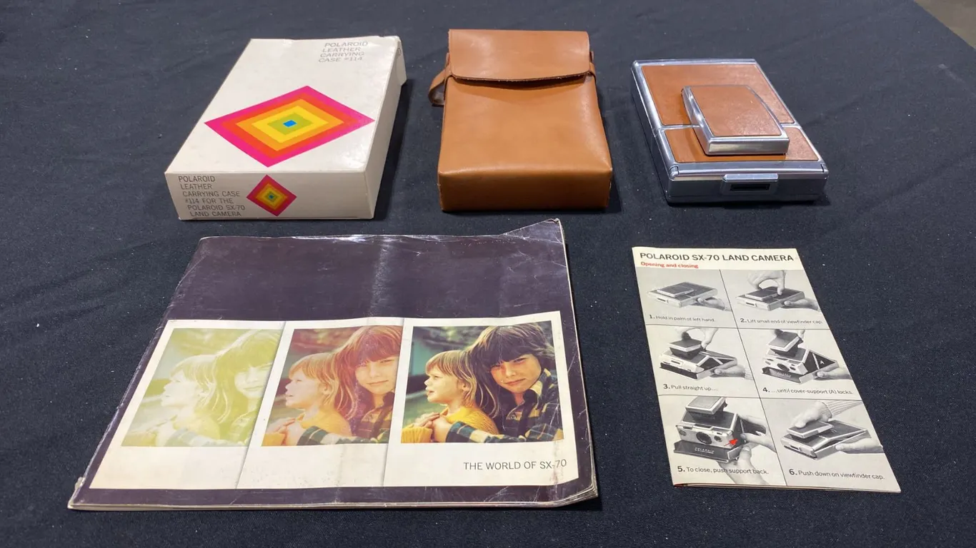 POLAROID SX-70 LAND CAMERA WITH LEATHER CASE AND MANUALS (TAN & CHROME)