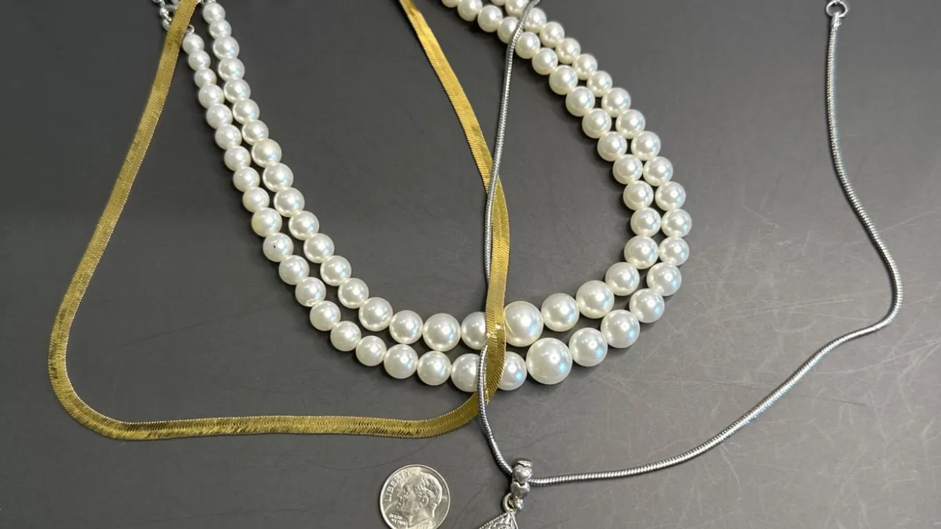 Three Necklaces: Faux Pearl, Teardrop Pendant, and Gold-Tone Chain