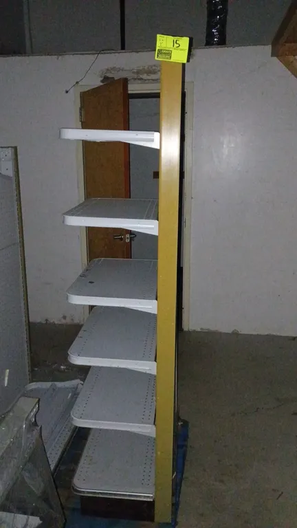 Madix wall shelving. Features pegboard backing, adjustable metal shelves, and yellow upright trim. Dimensions: 26" x 72" x 17". Note: Sold by the foot