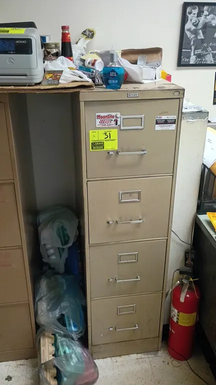 4-drawer vertical filing cabinets. Features metal construction, integrated label holders, and pull handles. Tan finish. 15" x 27" x 52". Contents not