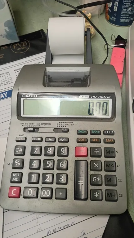 Desktop printing calculators. Includes Casio HR-100TM 12-digit printing calculator and electronic desktop printing calculator. Features paper tape fee