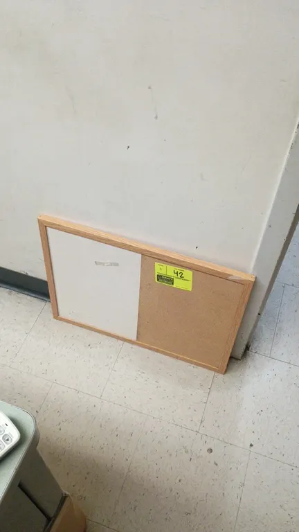 Bulletin boards. Includes (1) combination cork and dry-erase board with wood-tone frame and (1) cork bulletin board with black frame. 23" x 17" each.
