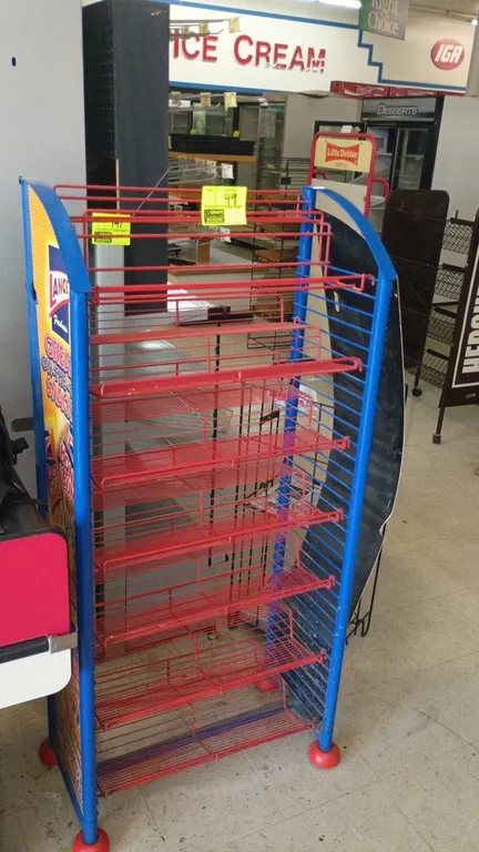 Lance 7-tier metal wire merchandiser rack. Features 7 red wire shelves, blue metal frame, and Lance snack side graphic panels. 28" x 14" x 50".