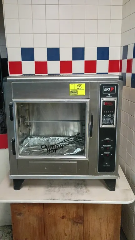 BKI FS commercial rotisserie oven. Features stainless steel construction, front glass door, digital programmable controls, internal rotor assembly, an