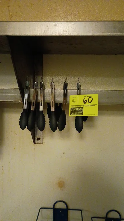 Kitchen utility tongs. Includes (6) tongs featuring stainless steel handles with black scalloped silicone tips and pull-ring locking mechanisms. Shelf