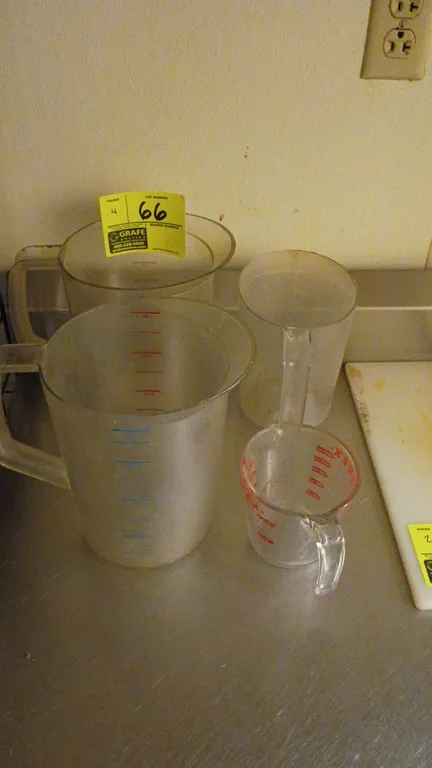 Assorted measuring cups. Features clear plastic construction with integrated handles, pour spouts, and graduated measurement markings. Includes variou