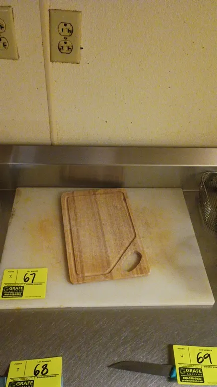 Assorted cutting boards. Includes (1) white polyethylene cutting board and (1) wood cutting board featuring a perimeter juice groove and integrated cu