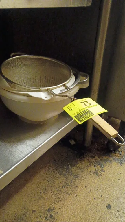 Assorted kitchen strainers and colanders. 4-piece set includes a stainless steel wire mesh strainer with wooden handle, a metal colander with dual sid