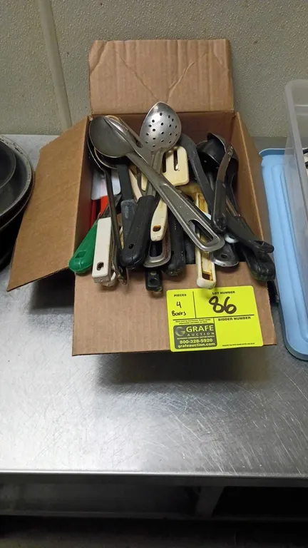 Assorted kitchen utensils. Includes spoons, slotted spoons, ladles, spatulas, whisks, kitchen shears, a box grater, rolling pin, and various food prep