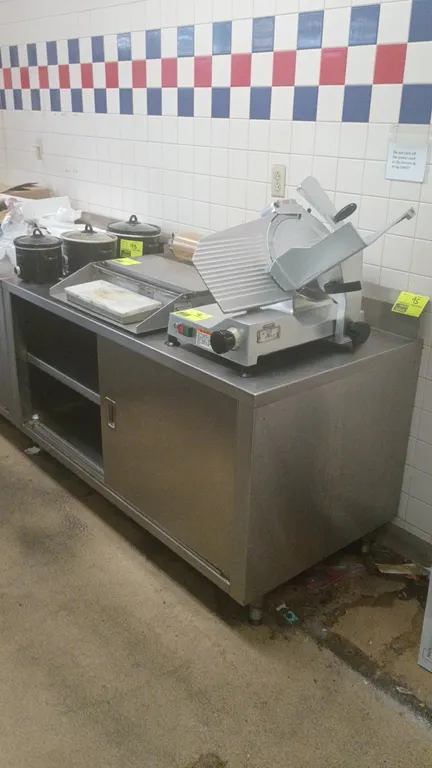 Stainless steel prep table with enclosed cabinet base. Features sliding doors, intermediate interior shelf, and small rear backsplash. 60"L x 30"W x 3